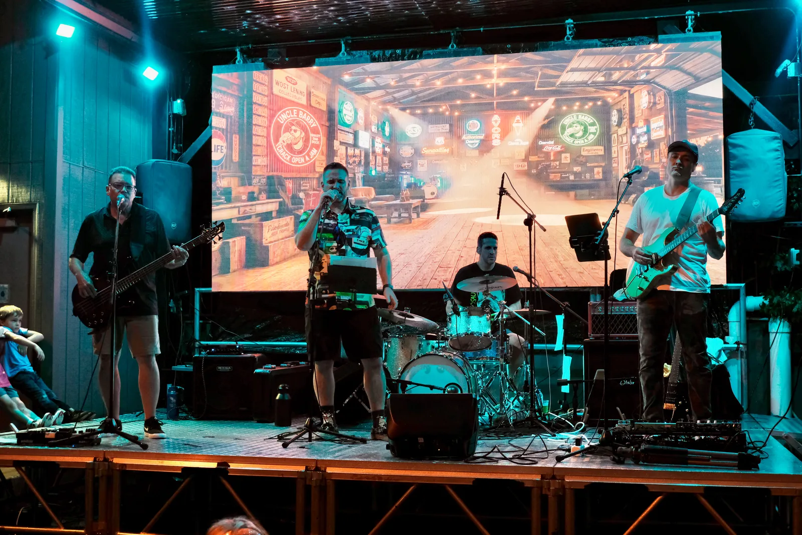 Full band with garage backdrop at Gate City Brewing