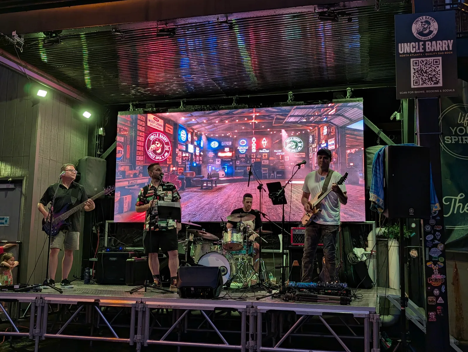 Nick on guitar with Josh and Richard watching him play at Gate City Brewing